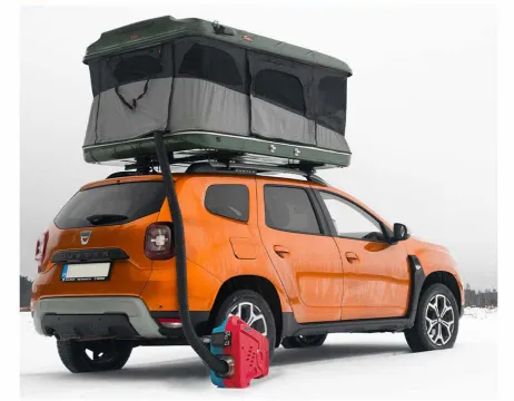 Overland vehicle with roof tent and portable heater in the snow